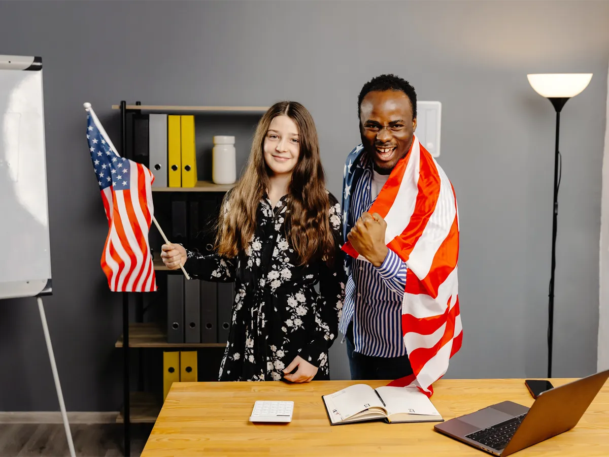 Two successful applicants smiling and celebrating after passing the US citizenship test