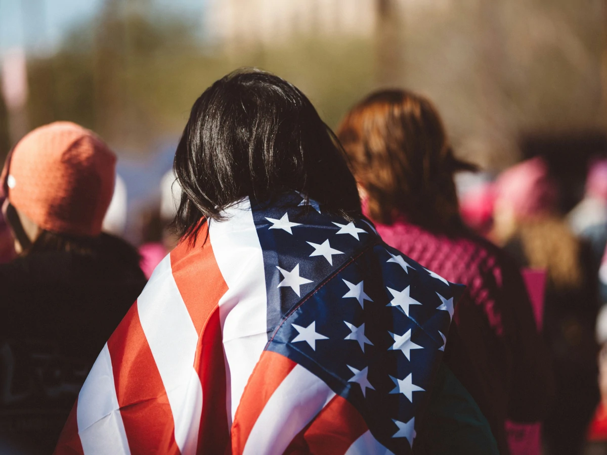 New US citizen wrapped in the American flag at their citizenship ceremony.