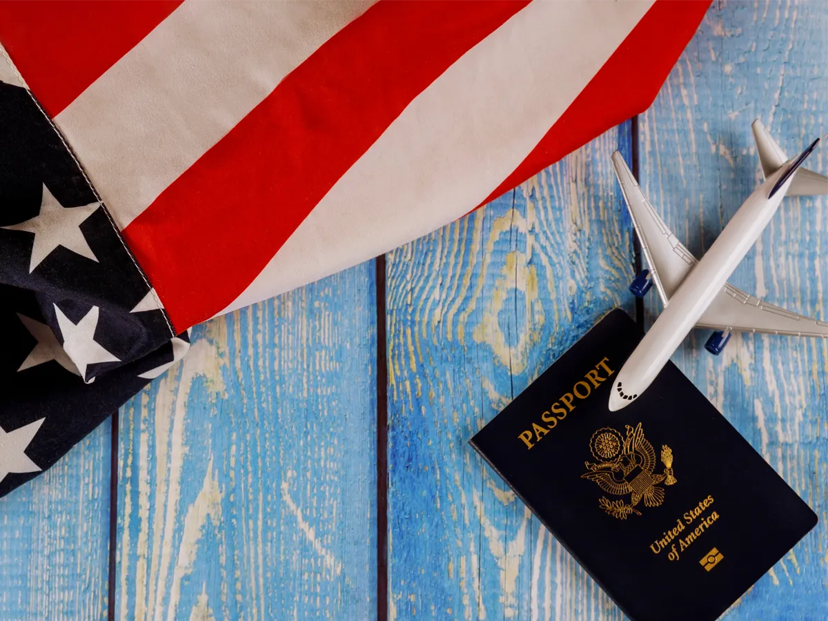 A U.S. passport resting on an application form, symbolizing the process of applying for a US passport