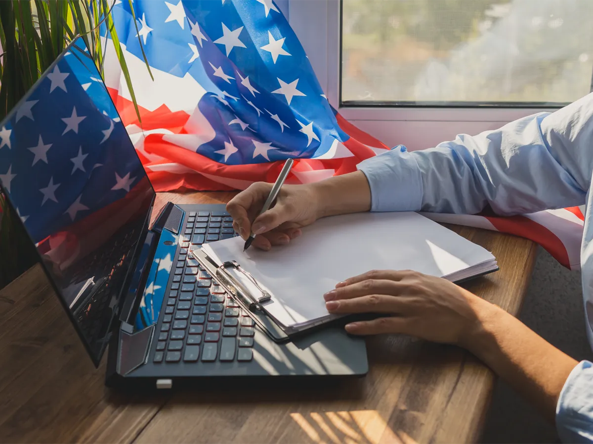 Person using a laptop to study for the US citizenship test changes in 2025