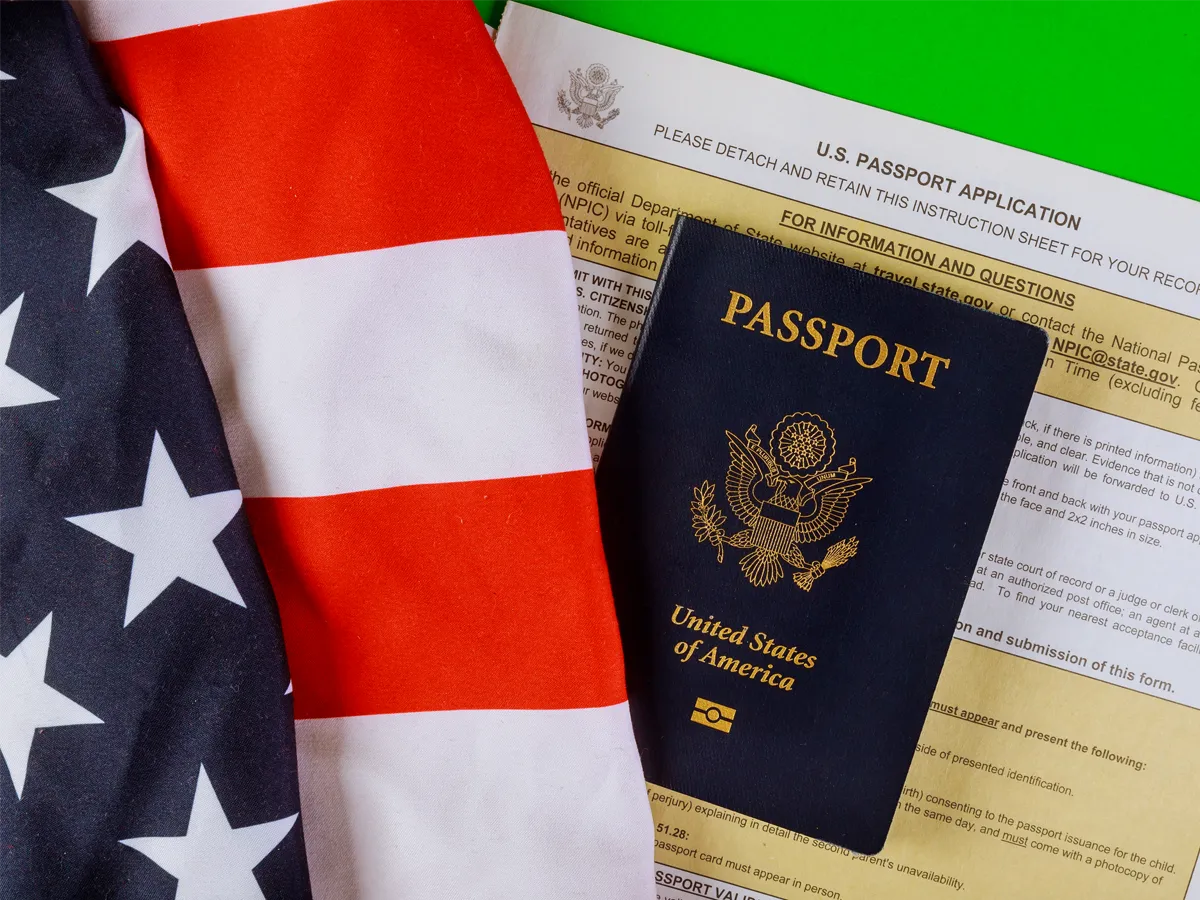 US passport with American flag and application form showing Status of US Passport Application