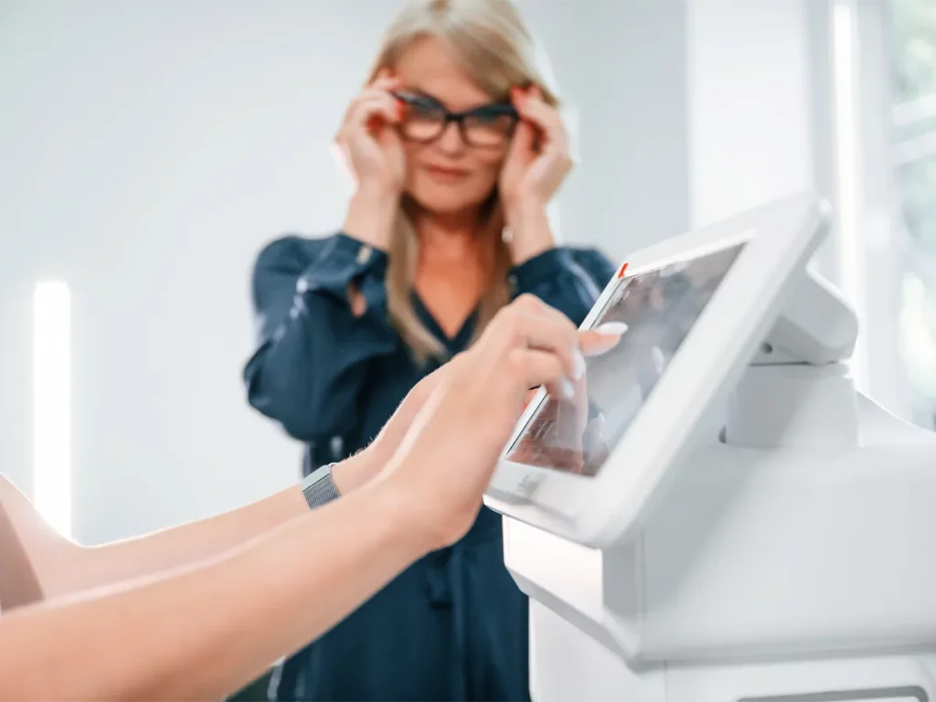 USCIS citizenship applicant scanning fingerprints during biometrics appointment.