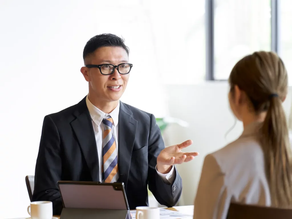 A candidate demonstrating the business casual dress code and professional body language for a U.S. citizenship interview
