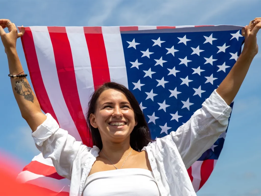 Why Is US Citizenship Important? Applicant with Flag Why Is US Citizenship Important? Applicant holding American flag