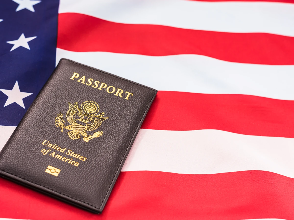 US passport and American flag representing N-400 travel history documentation
