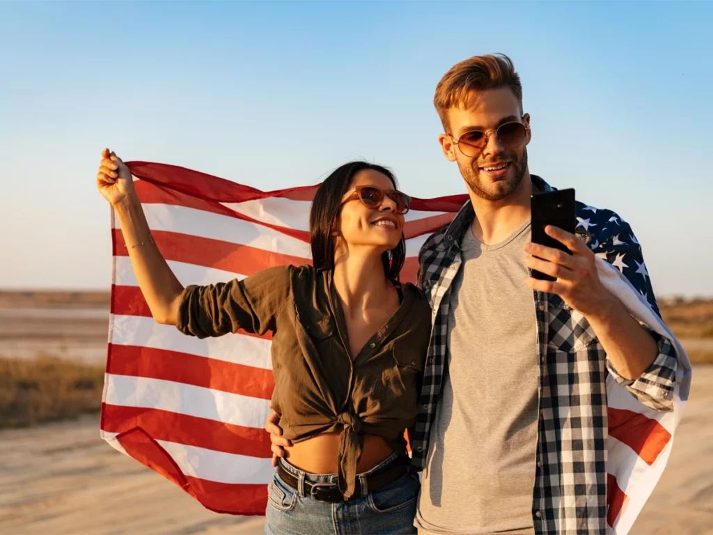 Applicants holding American flags and thinking, can I travel while N-400 is pending?