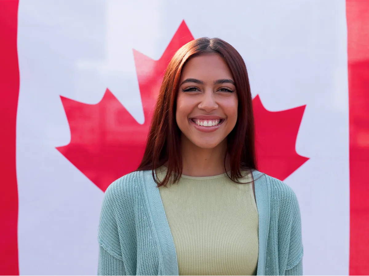 Applicant holding the Canadian flag after completing the process, symbolizing success in the processing time for Canadian citizenship.