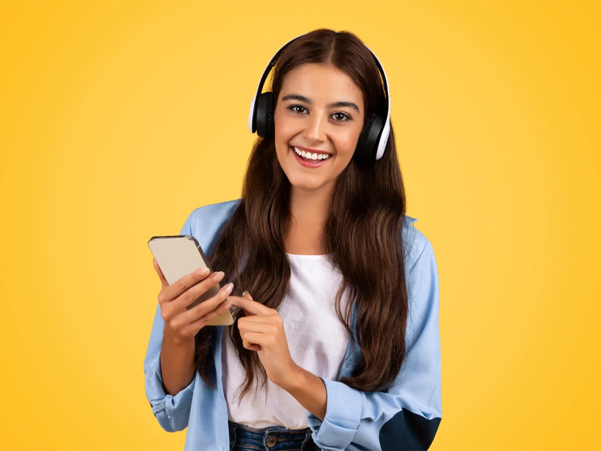 Applicant studying with headphones using citizenship apps to prepare for the U.S. civics test.
