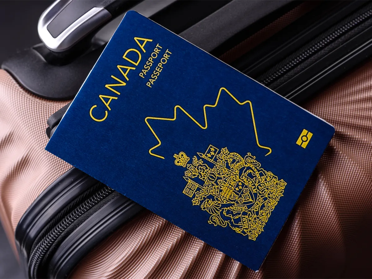 Canadian passport on a suitcase showing canadian passport process time before travel