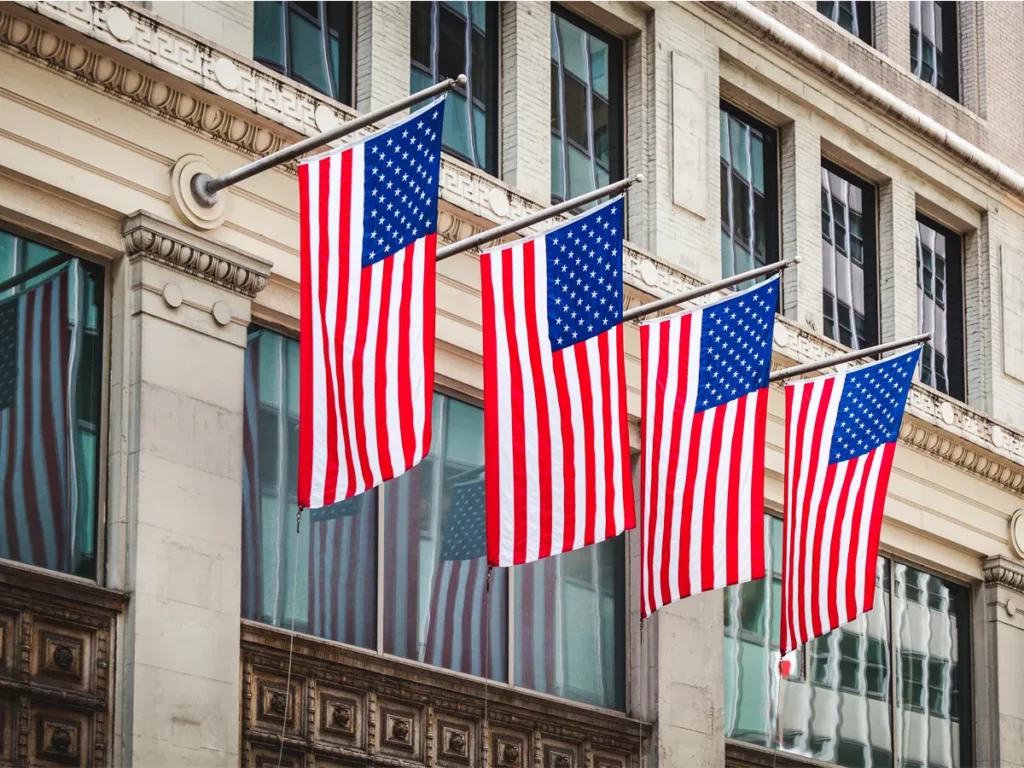 Official U.S. government building with the American flag, representing shared consular services for citizens and visa applicants.