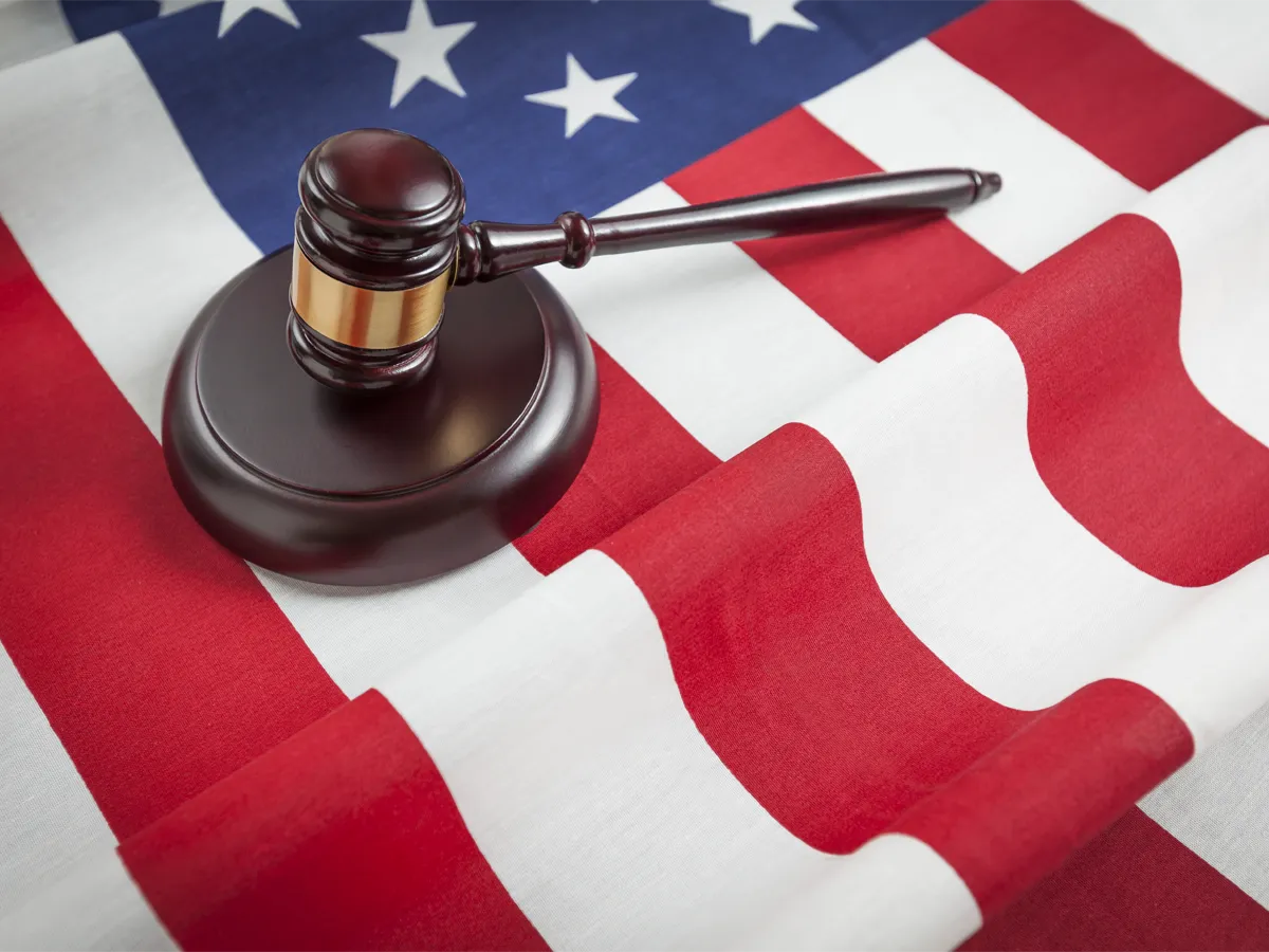 A wooden judge's gavel over an American flag representing the Exclusive Citizenship Act of 2025 legal review.